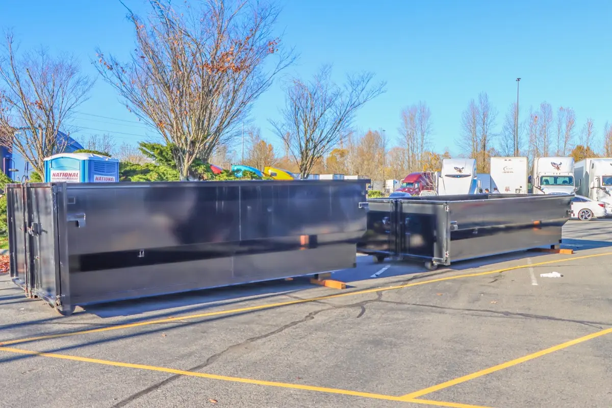 Professional dumpster rental service with roll-off container on residential driveway in West Miami